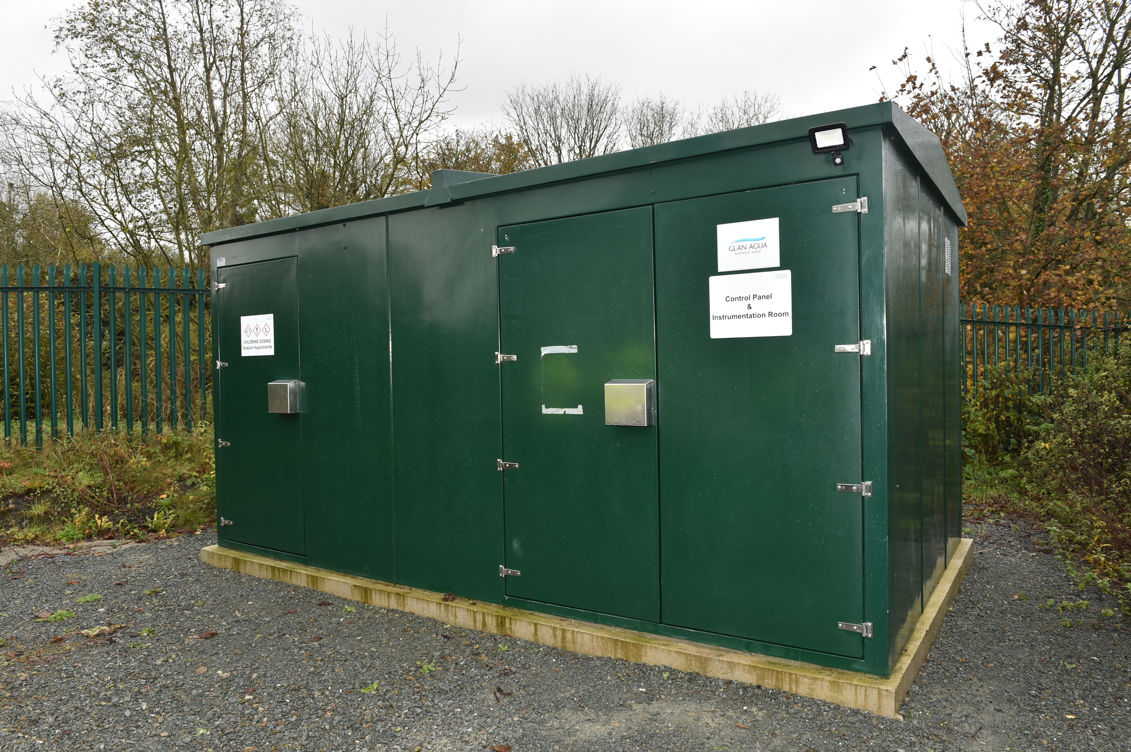 A small green metal building