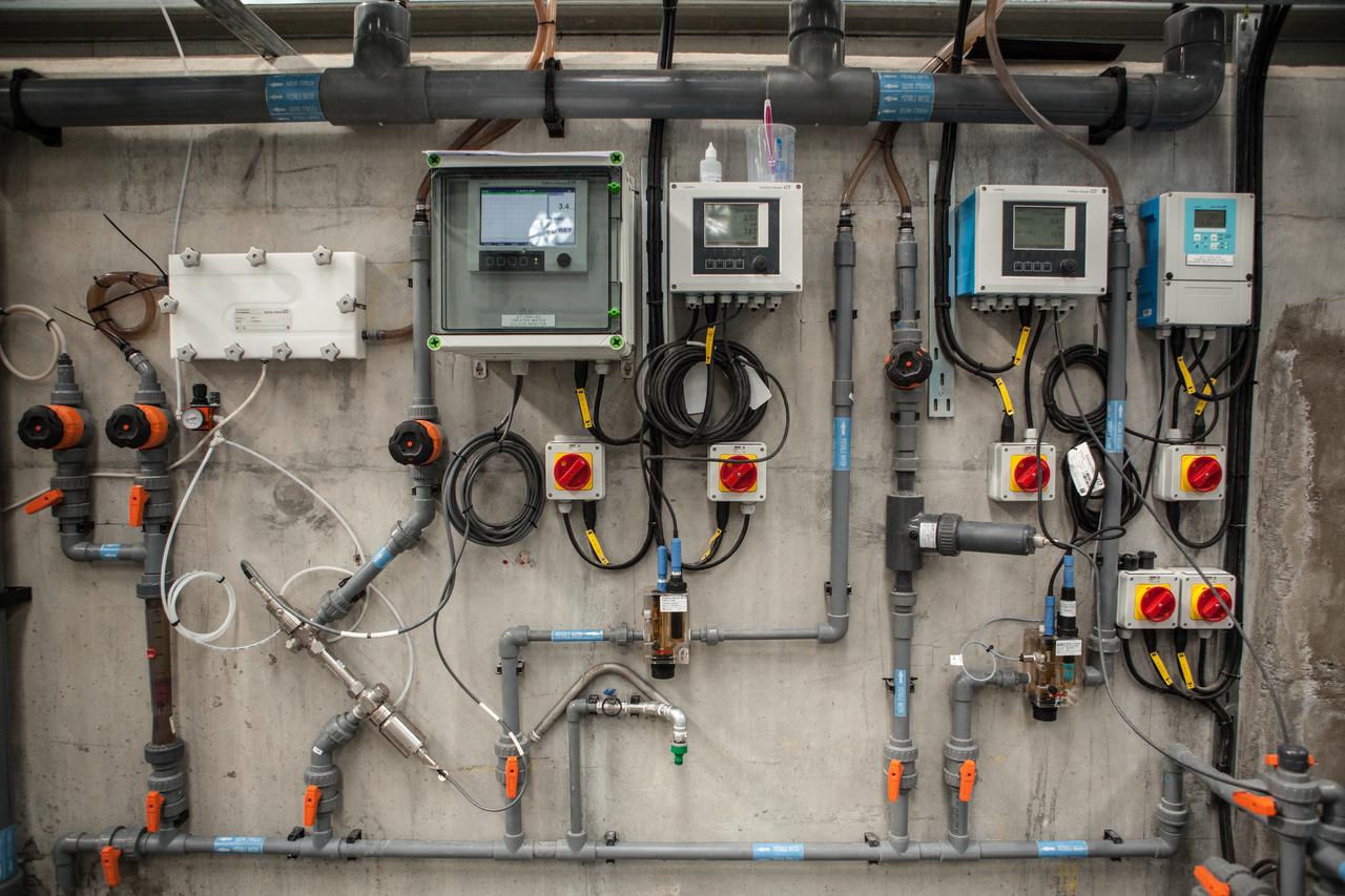 A wall covered in pipes and machinery