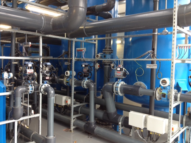 Piping and blue tanks in a water treatment plant