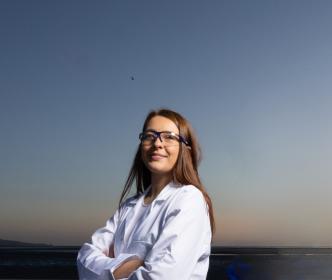 A person wearing safety glasses on a beach