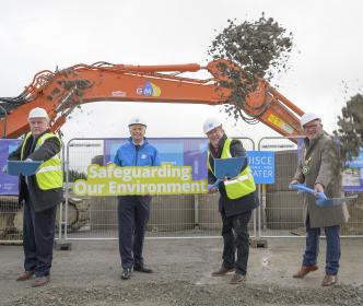 A group of people holding shovels and a sign reading "Safeguarding Our Environment"